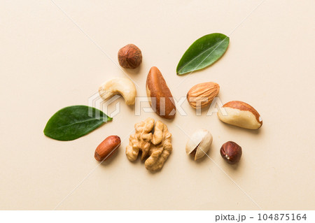 Composition of nuts , flat lay - mix hazelnuts, cashews, almonds on table background. healthy eating concepts and food background 104875164