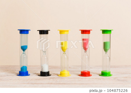 hourglass on the table, sand clock as time passing concept for business deadline, copy space hourglass on the table, sand clock as time passing concept for business deadline, copy space 104875226