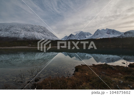 Panorama view and reflection of the Lake Aspevatnet in Svensby, Norway. 104875602