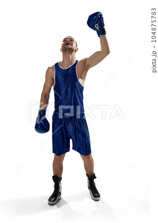 Full-length image of young sportive man , professional boxer in uniform and gloves standing isolated over white background 104875783