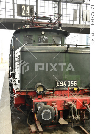 Vertical shot of a historic traditional locomotive at the museum station Vertical shot of a historic traditional locomotive at the museum station 104875971