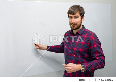 A young man conducts online training in the office. A young man conducts online training in the office. 104876803