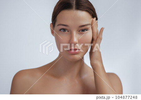 Anti Aging Treatment and Facelift Skin Care Concept. Woman with hand on cheek and eye Anti Aging Treatment and Facelift Skin Care Concept. Woman with hand on cheek and eye 104877248