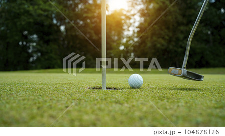 Golf balls that are going to be hole by golfers at the green grass golf course at sunset. Golf balls that are going to be hole by golfers at the green grass golf course at sunset. 104878126