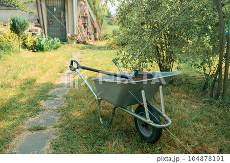 Garden cart with peat on the lawn close-up. 104878191