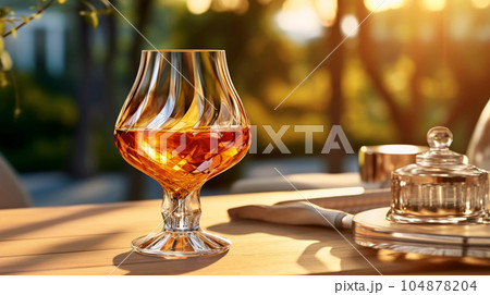 Glass of cognac in a hotel in the background of nature, alcoholic concept, expensive drink Glass of cognac in a hotel in the background of nature, alcoholic concept, expensive drink 104878204