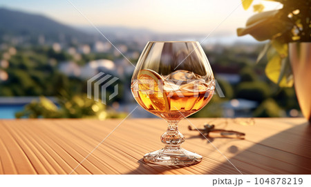 Glass of cognac in a hotel in the background of nature, alcoholic concept, expensive drink Glass of cognac in a hotel in the background of nature, alcoholic concept, expensive drink 104878219