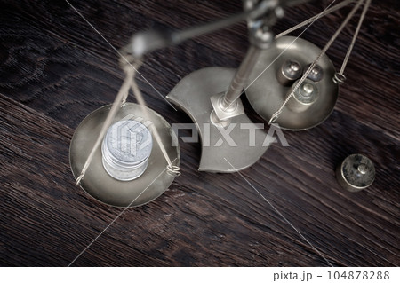 Retro weighing scale with silver dollar coin 104878288