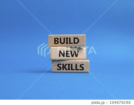 Build New skills symbol. Concept word Build New skills on wooden blocks. Beautiful blue background. Business and Build New skills concept. Copy space Build New skills symbol. Concept word Build New skills on wooden blocks. Beautiful blue background. Business and Build New skills concept. Copy space 104879298