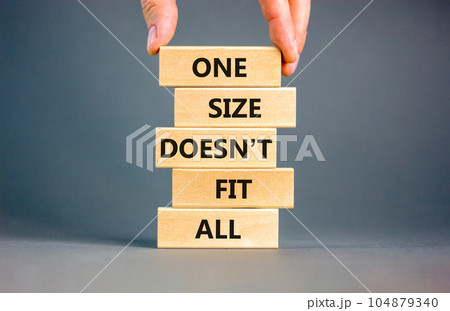 One size does not fit all symbol. Concept words One size does not fit all on wooden blocks. Businessman hand. Beautiful grey background. One size does not fit all business concept. Copy space. 104879340