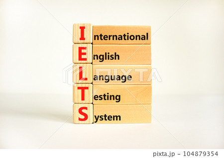 IELTS symbol. Concept words IELTS international english language testing system on wooden block. Beautiful white background. Business IELTS international english language testing system concept. 104879354