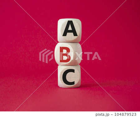 ABC symbol. Concept word ABC on wooden blocks. Beautiful red background. Business and ABC concept. Copy space 104879523