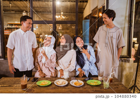 a group of Muslim friends chatting during iftar at an cafe 104880340