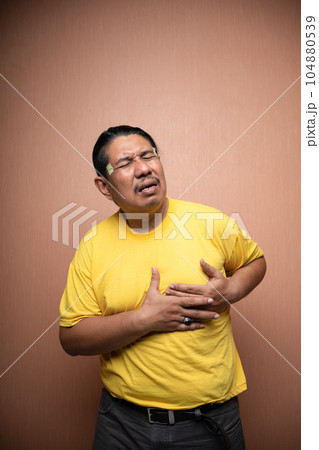 old asian man suffering from chest pain clenching chest old asian man suffering from chest pain clenching chest 104880539