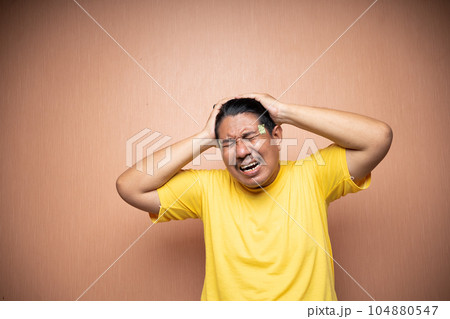 asian old man feeling headache migraine with clenching head gesture 104880547