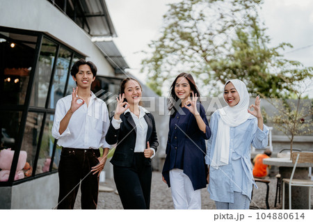 Group of cheerful young businesspeople with okay hand gestures 104880614