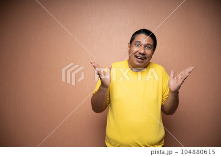 old asian man with open arm or welcoming gesture in plain background 104880615