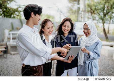 modern young people in casual clothes discussing business using a digital tablet 104880785