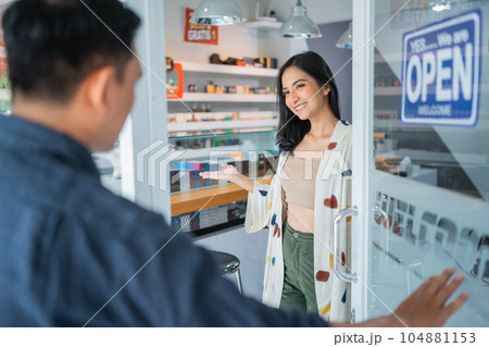 female vape seller welcoming the male customer female vape seller welcoming the male customer 104881153
