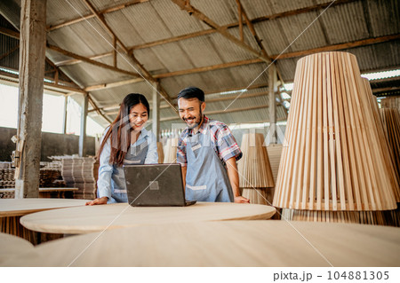 Asian business couple using a laptop computer together Asian business couple using a laptop computer together 104881305