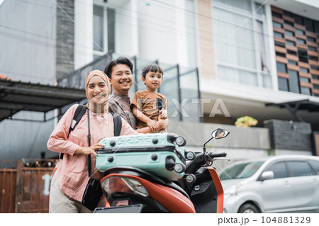 muslim family going with motorbike together during eid mubarak 104881329