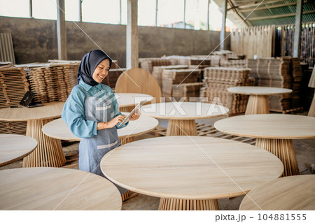 asian woman dressed in religious veil using a tablet computer 104881555