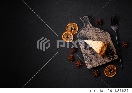 Delicious sweet cheesecake cake on textured concrete background 104881627