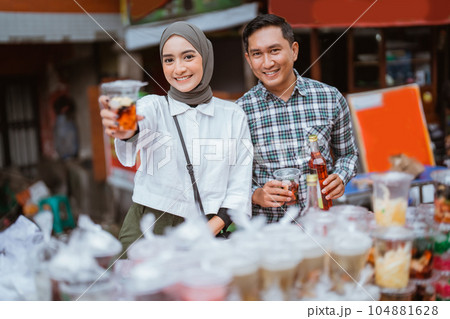 girl in a veil and a man sells mix fruit beverage and juice girl in a veil and a man sells mix fruit beverage and juice 104881628