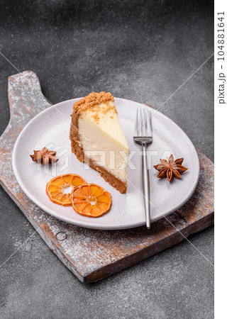 Delicious sweet cheesecake cake on textured concrete background 104881641