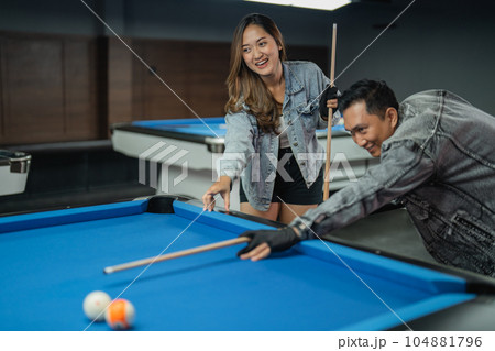 male pool player poking the object ball 104881796
