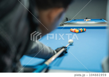 white ball poked by the male billiard player white ball poked by the male billiard player 104881959