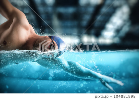 Sporty man athlete swims with energy during a competition in the pool Sporty man athlete swims with energy during a competition in the pool 104881998