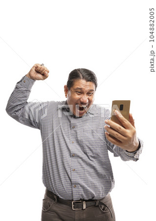 old asian man celebrating success while holding phone white background 104882005