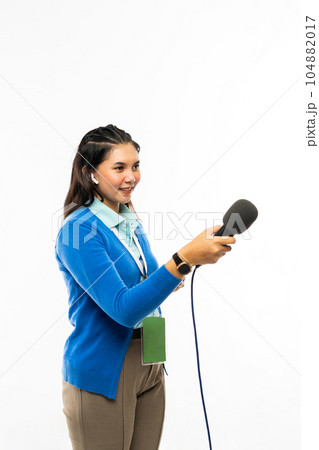 a beautiful reporter standing hand over a microphone a beautiful reporter standing hand over a microphone 104882017
