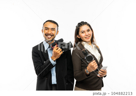 a male journalist standing beside a female journalist a male journalist standing beside a female journalist 104882213