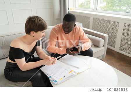Couple of young people doing house paperwork 104882618