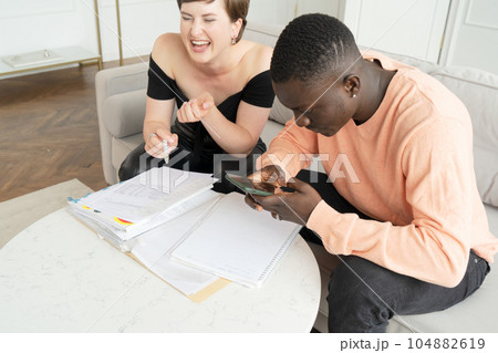 Couple of young people doing house paperwork 104882619