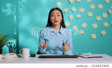 Cheerful human resources asian interviewer in online video call meeting prospecting potential candidate. Smiling businesswoman online interviewing applicant in colourful office 104883969