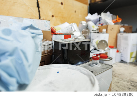 Industrial metal cans with paint and technical liquid in storeroom 104889280