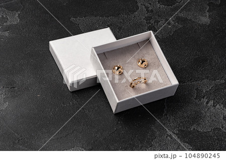 Jewelry box with earrings on a gray background Jewelry box with earrings on a gray background 104890245