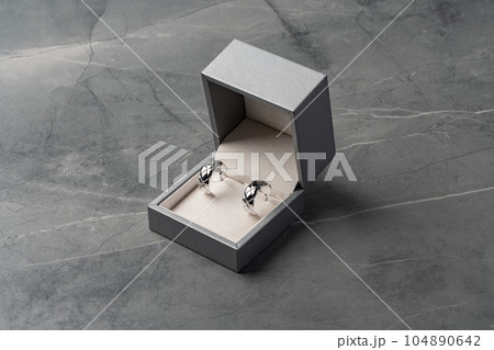 Jewelry box with earrings on a gray background 104890642