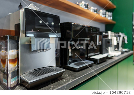 Row of many coffee machines on sale in store 104890718