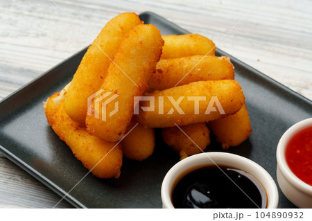 Fried snacks platter with sauce on gray wooden table Fried snacks platter with sauce on gray wooden table 104890932