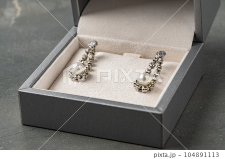 Jewelry box with earrings on a gray background 104891113