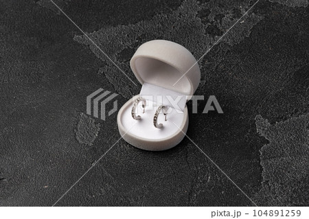 Jewelry box with earrings on a gray background Jewelry box with earrings on a gray background 104891259