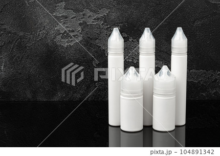 Electronic cigarette vape liquids on black background 104891342