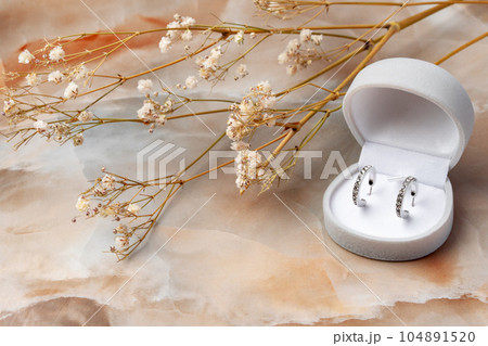 Golden earrings and jewelry box on table close up Golden earrings and jewelry box on table close up 104891520