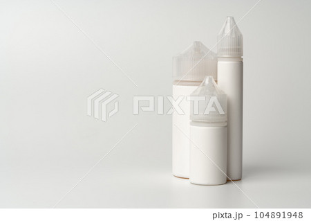 Refill liquid for electronic cigarettes on gray background 104891948