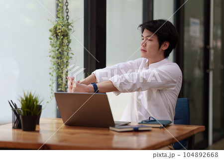 Businessman in office relaxing in chair. Resting with thoughtful mind thinking of life quality Businessman in office relaxing in chair. Resting with thoughtful mind thinking of life quality 104892668