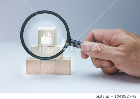 Hand holding magnifying glass to analyze money icon, bank account business concept. Hand holding magnifying glass to analyze money icon, bank account business concept. 104892748